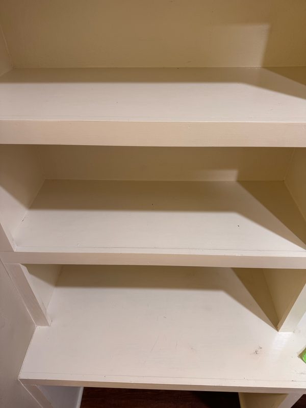 The same three shelves after cleaning, wiped down with no marks left on any of them.